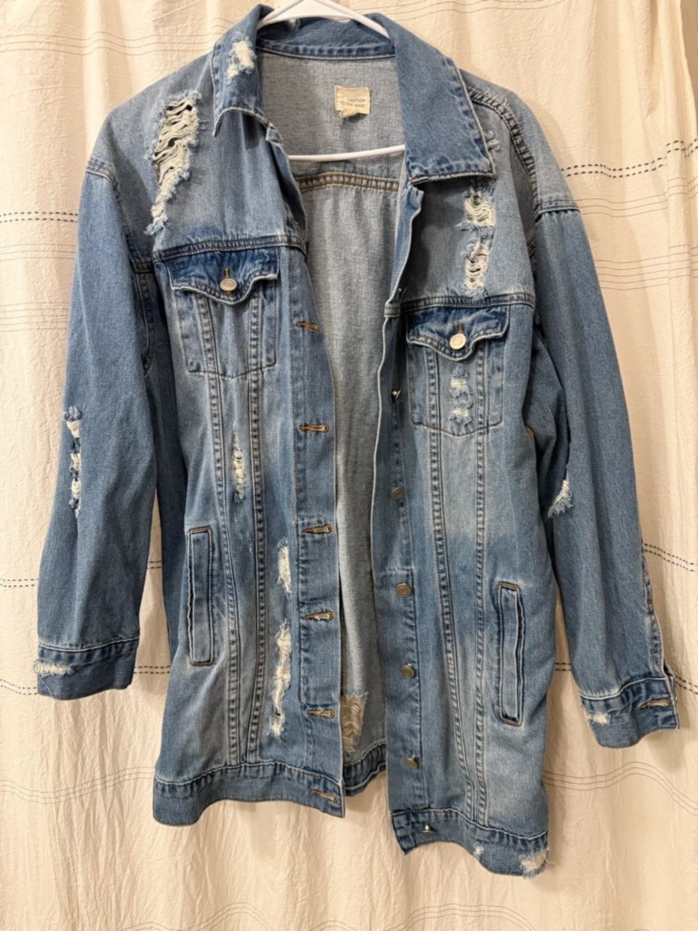 Distressed long denim jacket